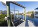 Boat Lift on the water with a boat parked near it at 6503 Santiago Ct, Apollo Beach, FL 33572