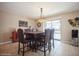 Dining room featuring a chandelier, tile flooring, and access to the screened-in patio and pool at 6503 Santiago Ct, Apollo Beach, FL 33572