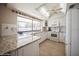Bright kitchen featuring white cabinetry, granite countertops, and a window over the sink with backyard views at 6503 Santiago Ct, Apollo Beach, FL 33572