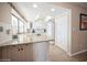 Bright kitchen with white cabinetry, granite countertops, tile flooring, and plenty of natural light at 6503 Santiago Ct, Apollo Beach, FL 33572