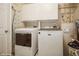 Well-equipped laundry area with modern washer and dryer, plus ample storage space at 6503 Santiago Ct, Apollo Beach, FL 33572