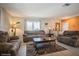 Comfortable living room with plush sofas, neutral decor, and a decorative rug, creating a warm and inviting atmosphere at 6503 Santiago Ct, Apollo Beach, FL 33572