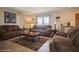 Cozy living room with plush sofas, neutral decor, and a decorative rug, creating a warm and inviting atmosphere at 6503 Santiago Ct, Apollo Beach, FL 33572