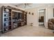 Stylish living room featuring a large entertainment center, tile floors, and views into an adjacent bedroom at 6503 Santiago Ct, Apollo Beach, FL 33572