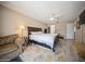 Large main bedroom featuring tile flooring, a ceiling fan, and a private sitting area at 6503 Santiago Ct, Apollo Beach, FL 33572
