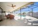 Inviting screened patio with comfortable seating overlooking the pool, perfect for outdoor relaxation and entertainment at 6503 Santiago Ct, Apollo Beach, FL 33572