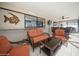 Covered patio featuring comfortable seating, a decorative fish, and views of the refreshing pool area at 6503 Santiago Ct, Apollo Beach, FL 33572