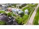 An aerial view of colorful waterfront homes, a well-manicured lawn, private docks and neighborhood streets at 6512 Simone Shores Cir, Apollo Beach, FL 33572