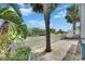 Charming backyard features a paved patio area with white picket fence overlooking waterfront at 6512 Simone Shores Cir, Apollo Beach, FL 33572