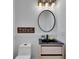 Stylish bathroom featuring a floating vanity, modern mirror, and contemporary lighting fixtures at 6512 Simone Shores Cir, Apollo Beach, FL 33572