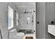 Modern bathroom featuring a glass shower with black fixtures and white marble-style tile and black honeycomb floor at 6512 Simone Shores Cir, Apollo Beach, FL 33572
