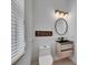 Chic bathroom featuring a floating vanity, modern mirror, and contemporary lighting fixtures at 6512 Simone Shores Cir, Apollo Beach, FL 33572