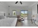 Bedroom showcasing a bed, chair with an ottoman, light floors, and sliding door to balcony at 6512 Simone Shores Cir, Apollo Beach, FL 33572