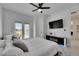 Bright bedroom with a ceiling fan, flat screen TV, and sliding door to private balcony at 6512 Simone Shores Cir, Apollo Beach, FL 33572