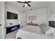 Bedroom featuring a ceiling fan, a flat screen TV, and an electric fireplace stand at 6512 Simone Shores Cir, Apollo Beach, FL 33572