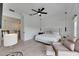 Bedroom featuring a ceiling fan, wood floors, a chair with an ottoman, and pendant lights at 6512 Simone Shores Cir, Apollo Beach, FL 33572