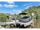 View of the boat dock, including a black pontoon boat at 6512 Simone Shores Cir, Apollo Beach, FL 33572