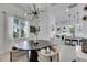 Stylish dining space with modern lighting, view of the kitchen, and an abundance of natural light at 6512 Simone Shores Cir, Apollo Beach, FL 33572