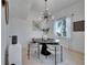 Elegant dining room boasts modern light fixture, stylish chairs and a view to the backyard at 6512 Simone Shores Cir, Apollo Beach, FL 33572