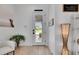Bright entrance features white door, modern lighting, and is decorated with plants and wall art at 6512 Simone Shores Cir, Apollo Beach, FL 33572