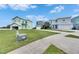 Colorful coastal home with a manicured lawn and attached two car garage at 6512 Simone Shores Cir, Apollo Beach, FL 33572