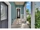 Inviting front porch features a quaint entrance with columns and outdoor plants at 6512 Simone Shores Cir, Apollo Beach, FL 33572