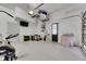 Spacious garage area features exercise equipment and overhead storage at 6512 Simone Shores Cir, Apollo Beach, FL 33572