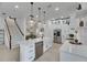 Bright, modern kitchen with white cabinets, stainless steel appliances and stylish hanging lights at 6512 Simone Shores Cir, Apollo Beach, FL 33572
