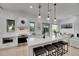 Well-lit kitchen with stainless steel appliances, white cabinets, and an island with seating, open to the living area at 6512 Simone Shores Cir, Apollo Beach, FL 33572