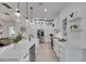 Modern kitchen with white cabinets, stainless steel appliances, a central island, and stylish pendant lighting at 6512 Simone Shores Cir, Apollo Beach, FL 33572
