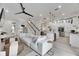 Bright, open-concept living room and kitchen with white walls, modern fixtures, and a large comfortable couch at 6512 Simone Shores Cir, Apollo Beach, FL 33572