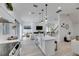 Spacious kitchen open to the living room, featuring an island with pendant lights and stainless steel appliances at 6512 Simone Shores Cir, Apollo Beach, FL 33572