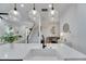 Open-concept living space with modern pendant lights, stairs, and large windows for natural light at 6512 Simone Shores Cir, Apollo Beach, FL 33572