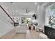 Open-concept living room featuring neutral tones, shiplap accent wall and modern fireplace at 6512 Simone Shores Cir, Apollo Beach, FL 33572