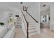 Inviting living room with stylish staircase, ample natural light, and an open layout at 6512 Simone Shores Cir, Apollo Beach, FL 33572