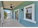 Covered porch featuring a ceiling fan and a sliding glass door at 6512 Simone Shores Cir, Apollo Beach, FL 33572