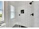 Glass enclosed shower with hexagon tile and bronze fixtures at 6512 Simone Shores Cir, Apollo Beach, FL 33572