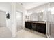 Elegant bathroom featuring dual sinks, granite countertops, and a glass-enclosed shower at 6711 Rocky Park St, Tampa, FL 33625