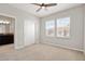 Bedroom features carpet, ceiling fan, two windows and an ensuite bath with granite counters at 6711 Rocky Park St, Tampa, FL 33625