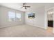 Bright bedroom featuring a ceiling fan, plush carpet, and ensuite bathroom at 6711 Rocky Park St, Tampa, FL 33625