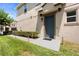 Home's front door with green grass, a sidewalk and professional landscaping at 6711 Rocky Park St, Tampa, FL 33625