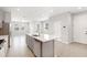 Open kitchen concept with island, stainless steel appliances, and tile flooring throughout at 6711 Rocky Park St, Tampa, FL 33625