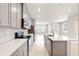 Modern kitchen featuring a sleek island with stone countertops and neutral-toned cabinetry at 6711 Rocky Park St, Tampa, FL 33625