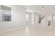 Open living area showcasing tile floors, a staircase, and ample natural light at 6711 Rocky Park St, Tampa, FL 33625