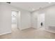 Neutral-toned living room leading to laundry room with carpeted floors at 6711 Rocky Park St, Tampa, FL 33625