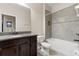 Bathroom featuring a granite vanity, toilet, and tiled shower-bathtub combo with a recessed shelf at 7001 Interbay Blvd # 242, Tampa, FL 33616