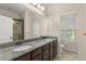Bathroom with granite countertop, double sinks, and modern fixtures at 7001 Interbay Blvd # 242, Tampa, FL 33616
