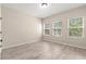 Bright bedroom with three windows providing lots of natural light and wood-look flooring at 7001 Interbay Blvd # 242, Tampa, FL 33616