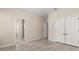 Spacious bedroom featuring wood-look floors and double door closet at 7001 Interbay Blvd # 242, Tampa, FL 33616
