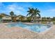A spacious community swimming pool with ample lounge chairs under the blue sky at 7001 Interbay Blvd # 242, Tampa, FL 33616